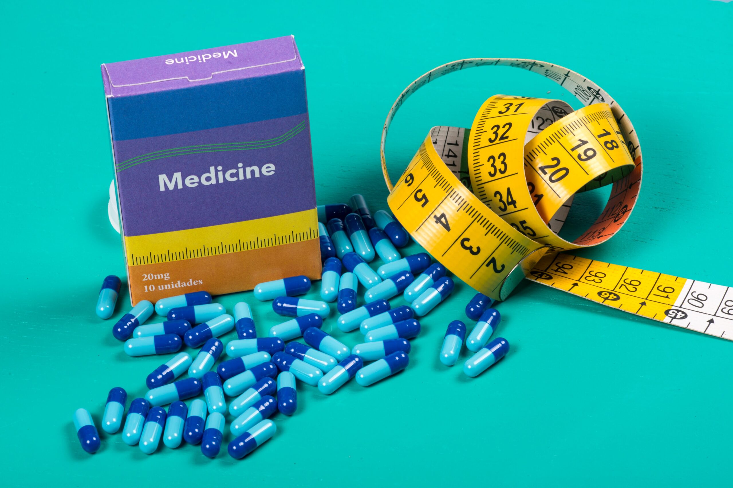 medicine-box-with-some-blue-capsule-and-measuring-