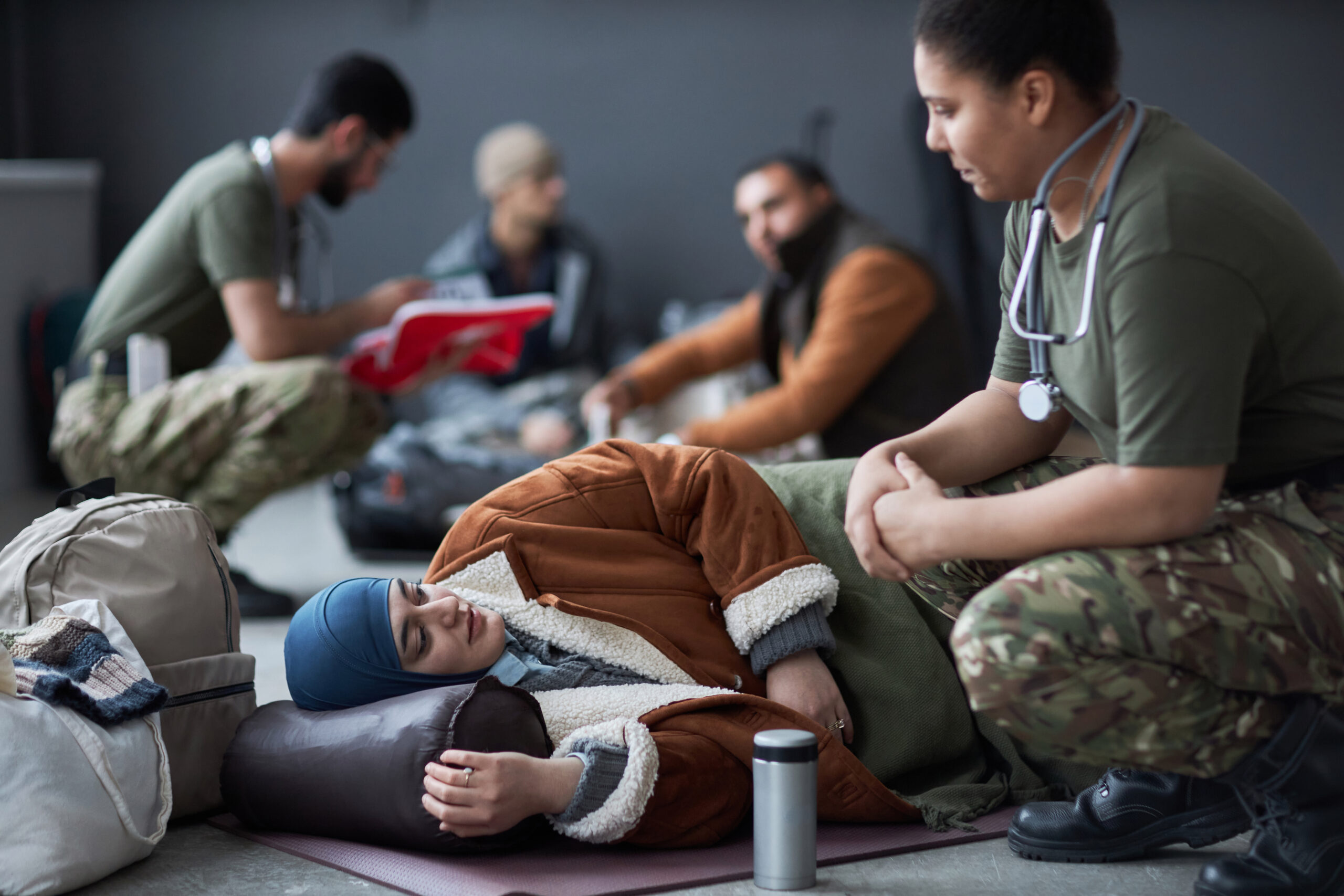 Middle Eastern Woman at Refugee Shelter Talking to Doctor